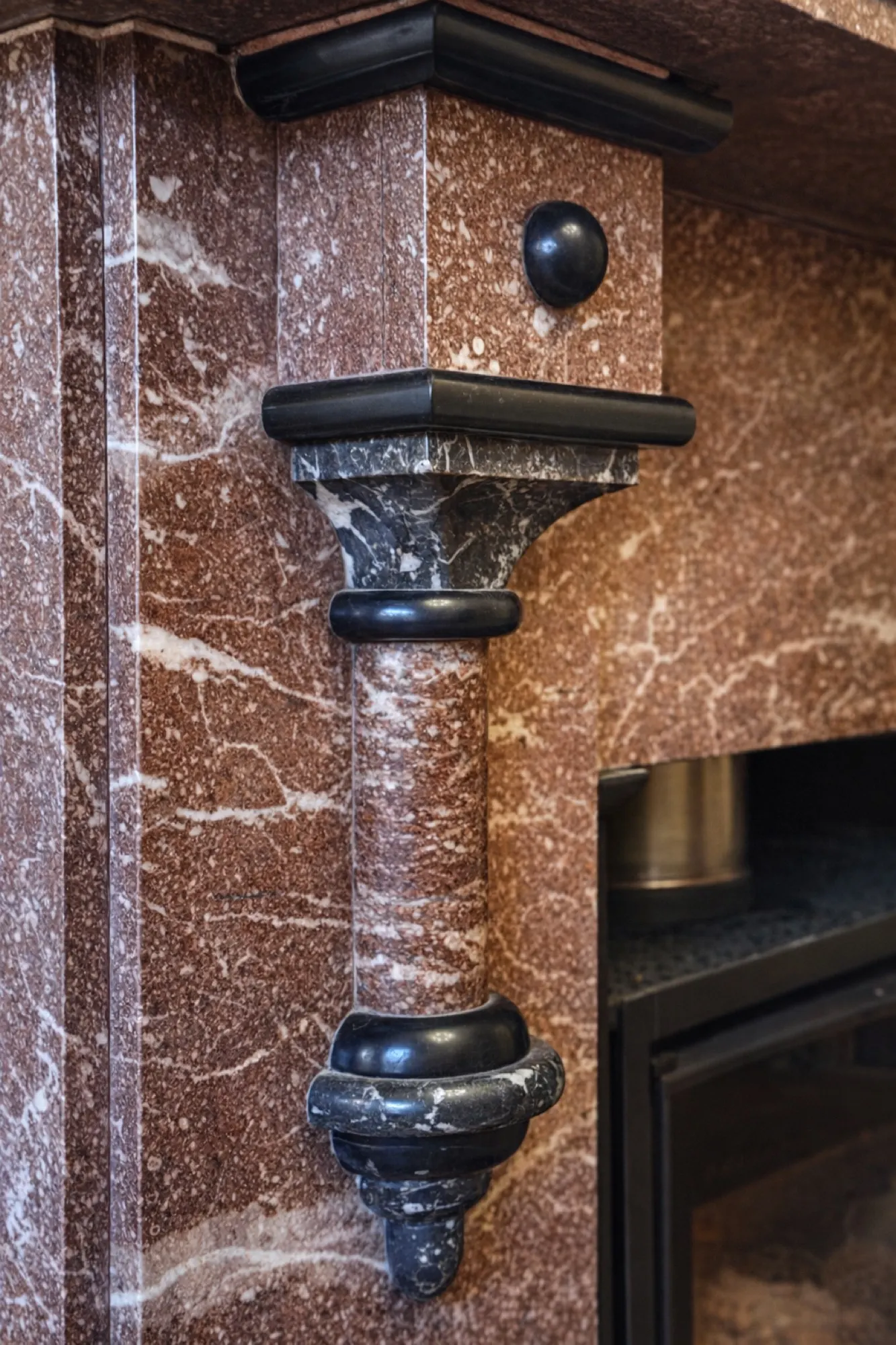 A carved marble fireplace in one of the principal rooms