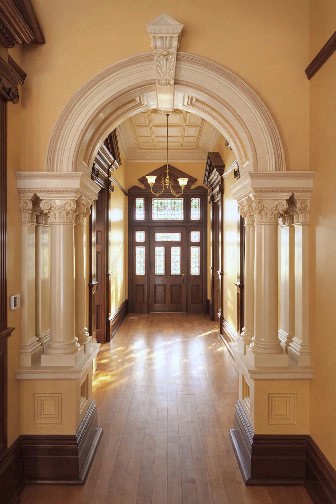 The full-length entrance hall, lit through original stained glass