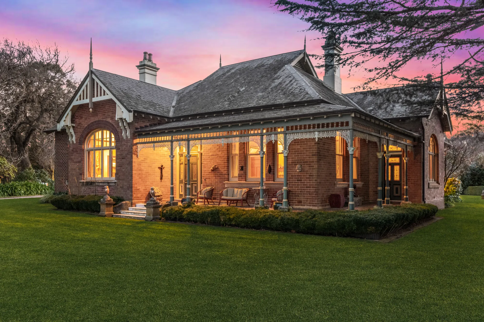 Seven Oaks, the heritage house glowing at dusk in its Southern Highlands garden